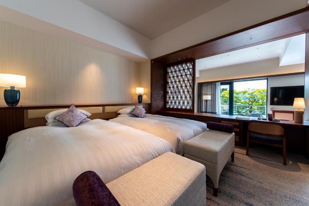 Postel nebo postele na pokoji v ubytování Hakone Hotel