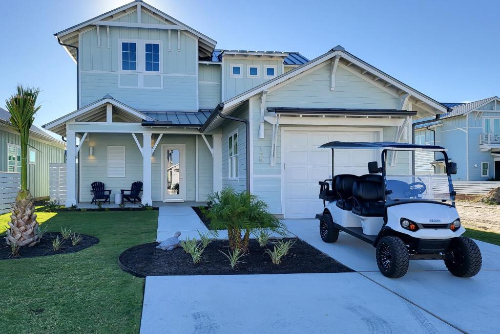 a golf cart parked in front of a house at Waterfront Wonderland in Rockport