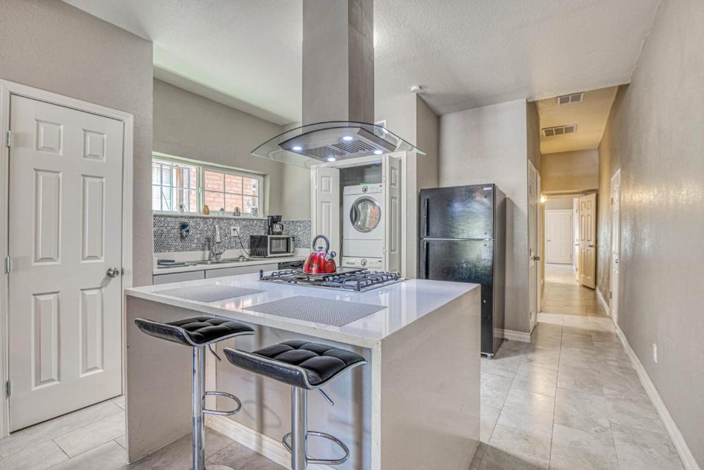 a kitchen with a sink and a refrigerator at Close to All, Restful Duplex A in Downtown, UTEP, Hospitals in El Paso