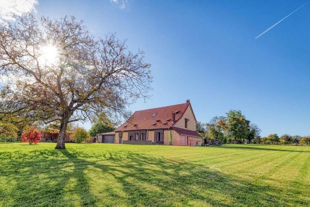 a large house in a field with a tree at Magnifique maison de campagne aux portes de Sancerre, by Rurals in Gardefort