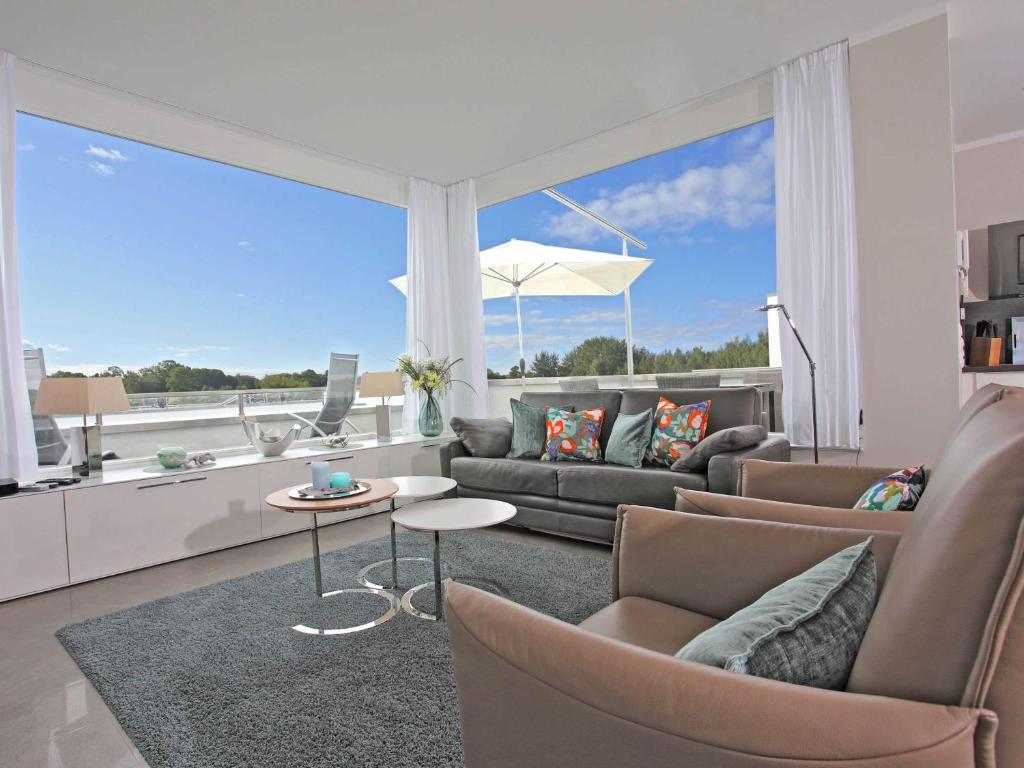 a living room with a couch and a table at Villa Sonneninsel in Binz - mit Sauna und zwei Terrassen in Binz