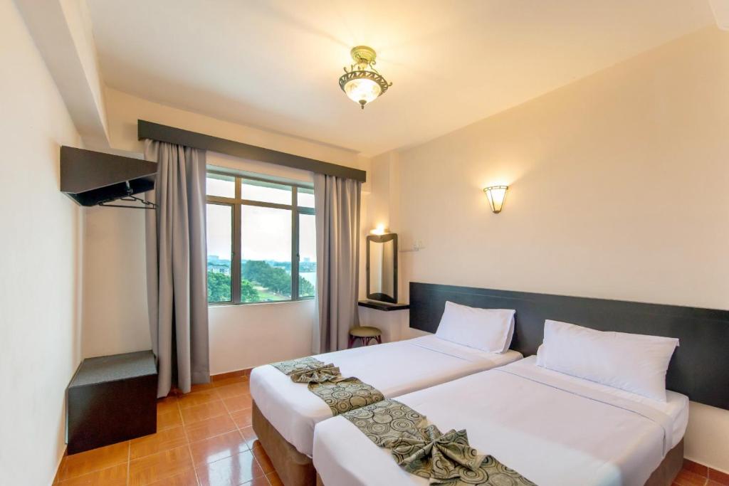 Postel nebo postele na pokoji v ubytování Glory Beach Resort