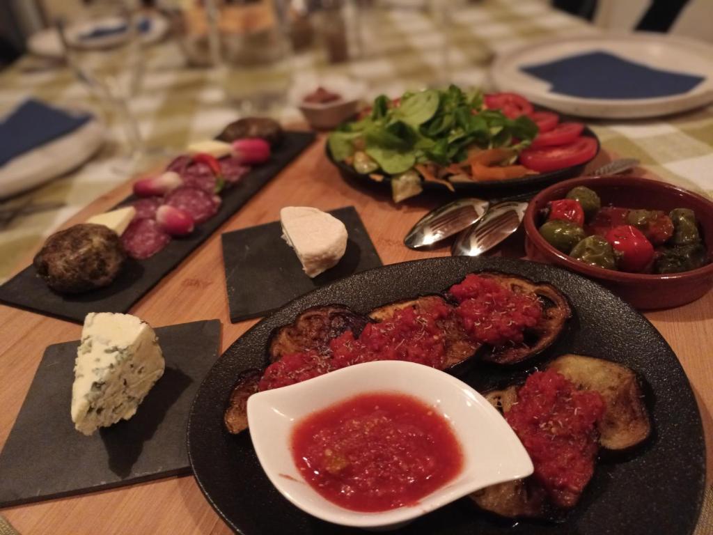 a table with plates of food on a table at Chambres d&#39;hôtes &amp; jacuzzi - A l&#39;ombre des amandiers in Saint-Martin-dʼArdèche