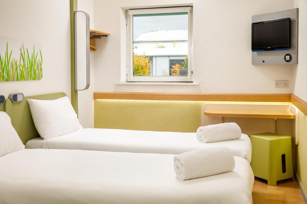 Postel nebo postele na pokoji v ubytování ibis budget Sheffield Arena