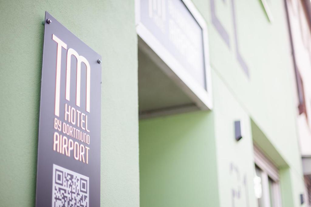 a sign on the side of a building at TM Hotel Dortmund Airport in Holzwickede