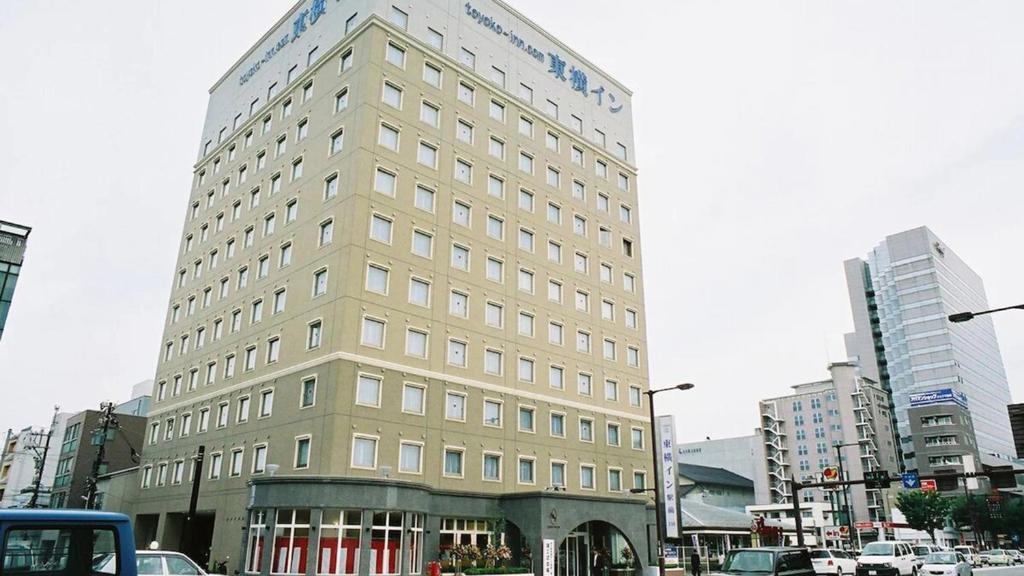 a large building on a city street with cars at Toyoko Inn Kanazawa-eki Higashi-guchi in Kanazawa