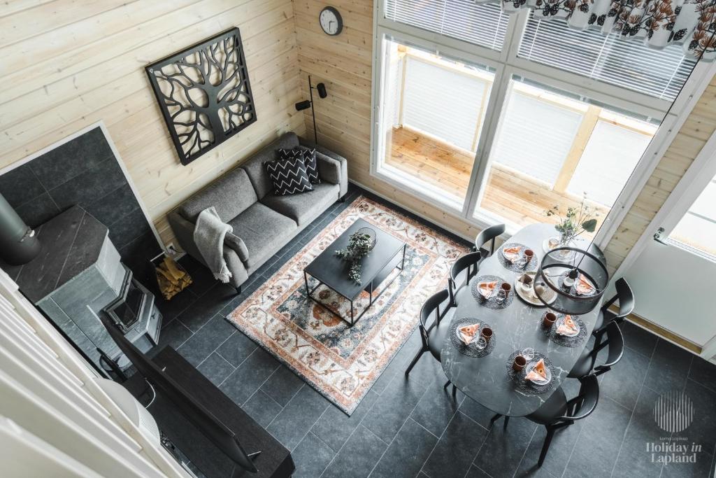 an overhead view of a living room with a table and chairs at Holiday in Lapland - Levihovi 6C in Levi