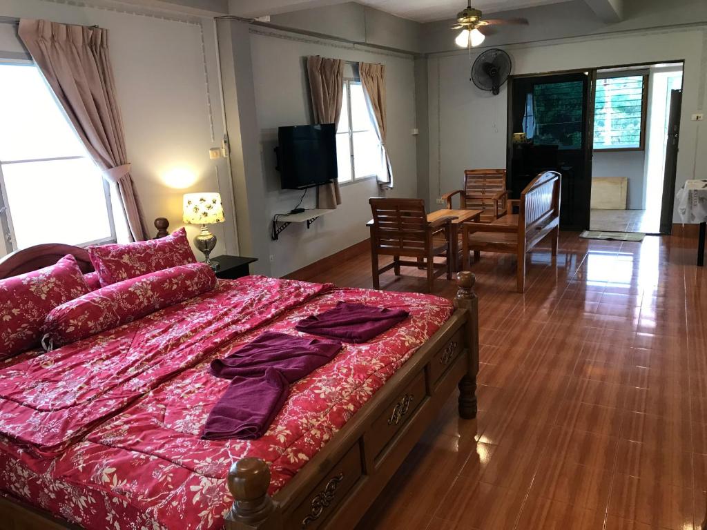 a bedroom with a large bed and a dining room at Apartment kata in Kata Beach
