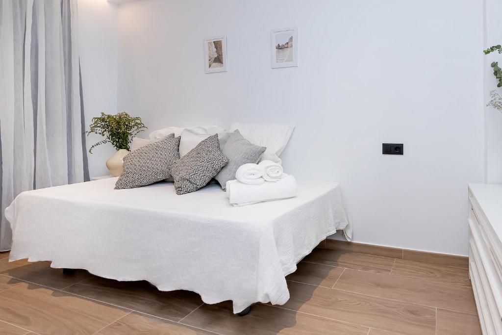 Łóżko lub łóżka w pokoju w obiekcie Amargura City Center Apartment