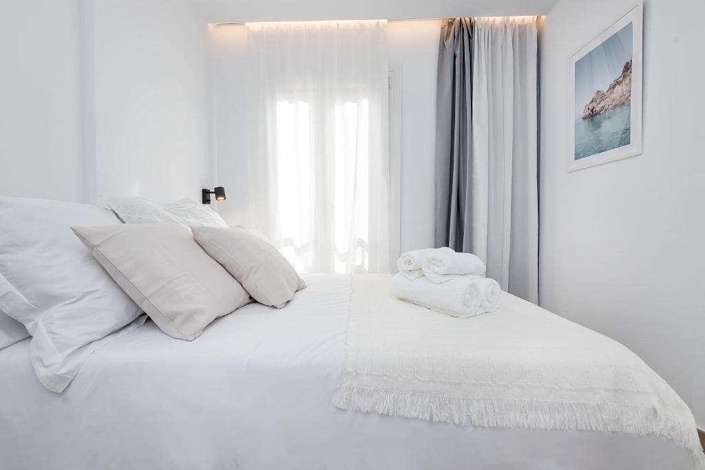 Łóżko lub łóżka w pokoju w obiekcie Amargura City Center Apartment