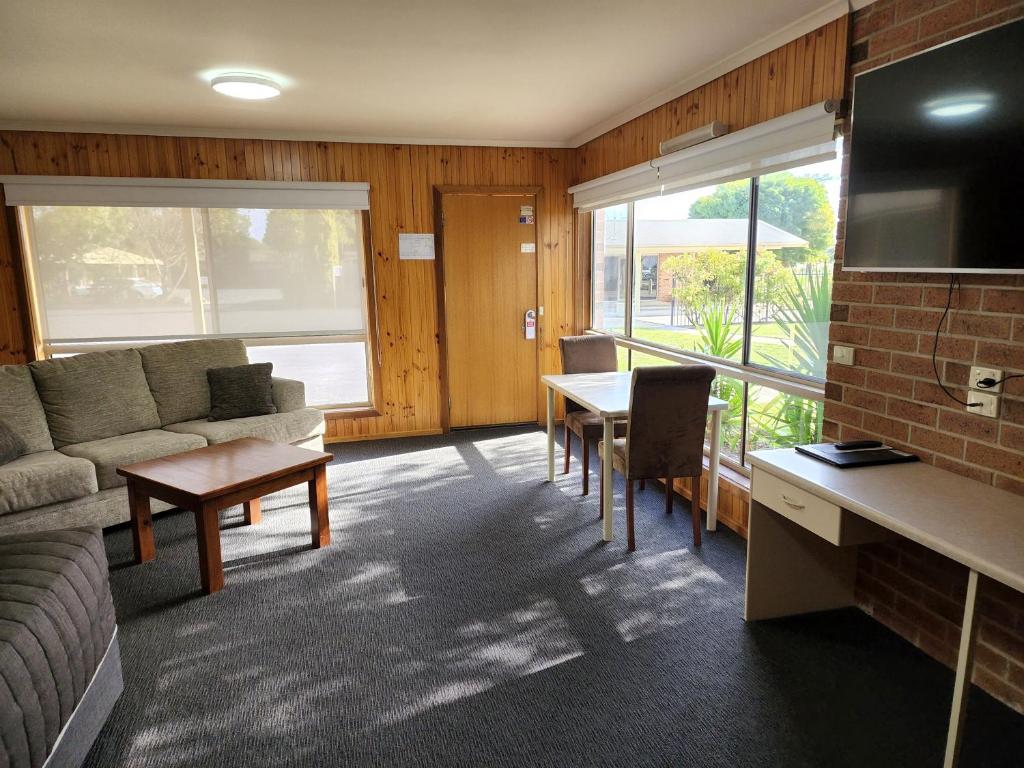 a living room with a couch and a table at Country Roads Motor Inn Naracoorte in Naracoorte