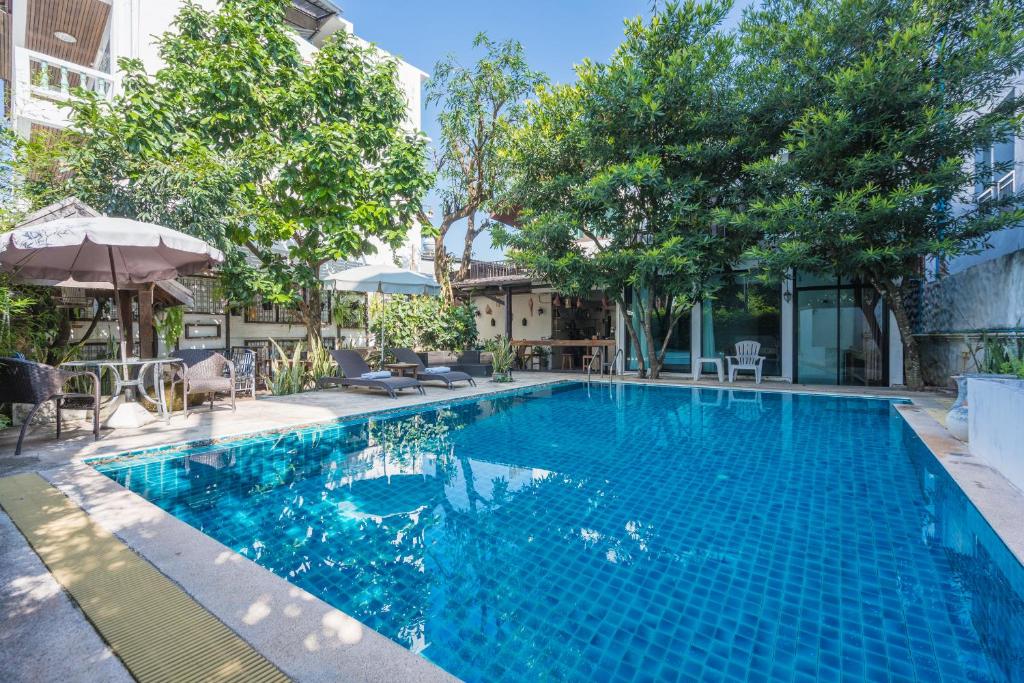 a swimming pool with blue water in a building at Yi's Garden Villa in Chiang Mai