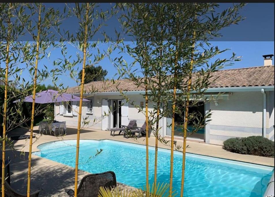 uma piscina em frente a uma casa em Magnifique Maison Piscine Andernos sur le Bassin d'Arcachon ! em Andernos-les-Bains