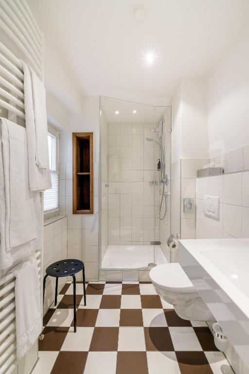a bathroom with a tub and a toilet and a sink at Bohemian Hotel in Regensburg
