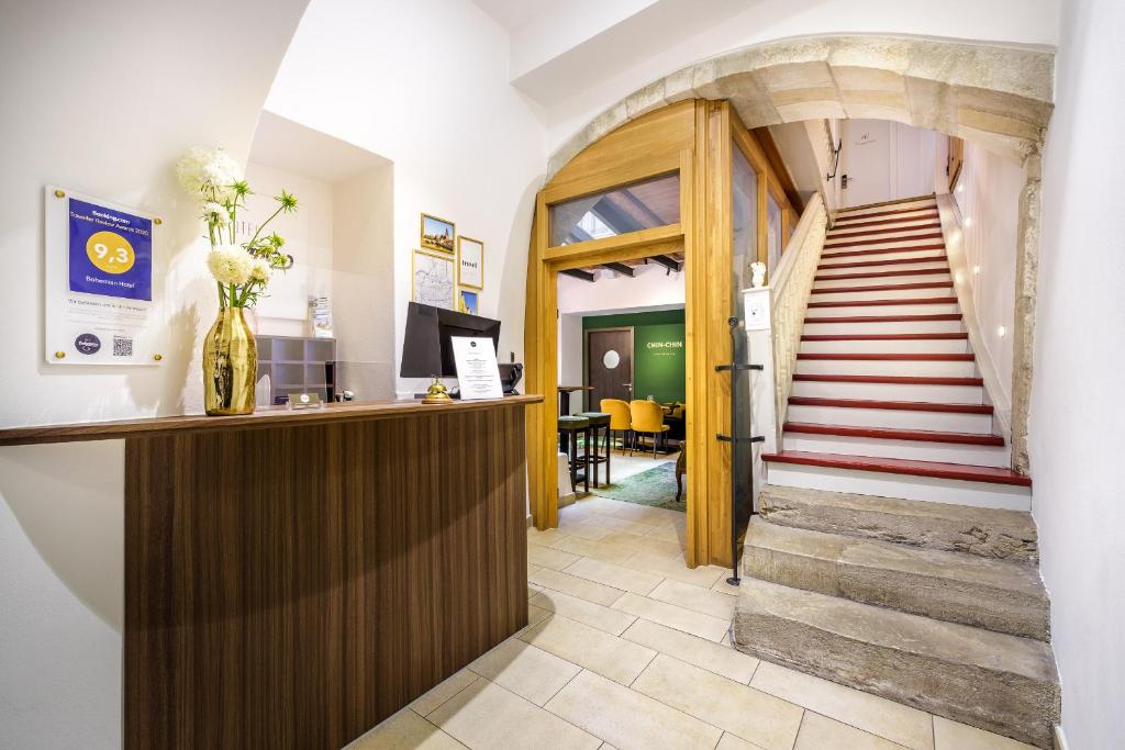 a hallway with a staircase and a lobby with a stair case at Bohemian Hotel in Regensburg