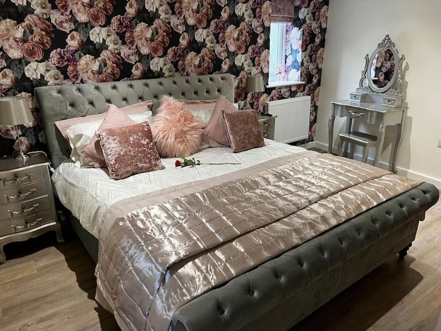 a bedroom with a large bed with a leather headboard at Ulverston stunning 1 bedroom apartment in Ulverston