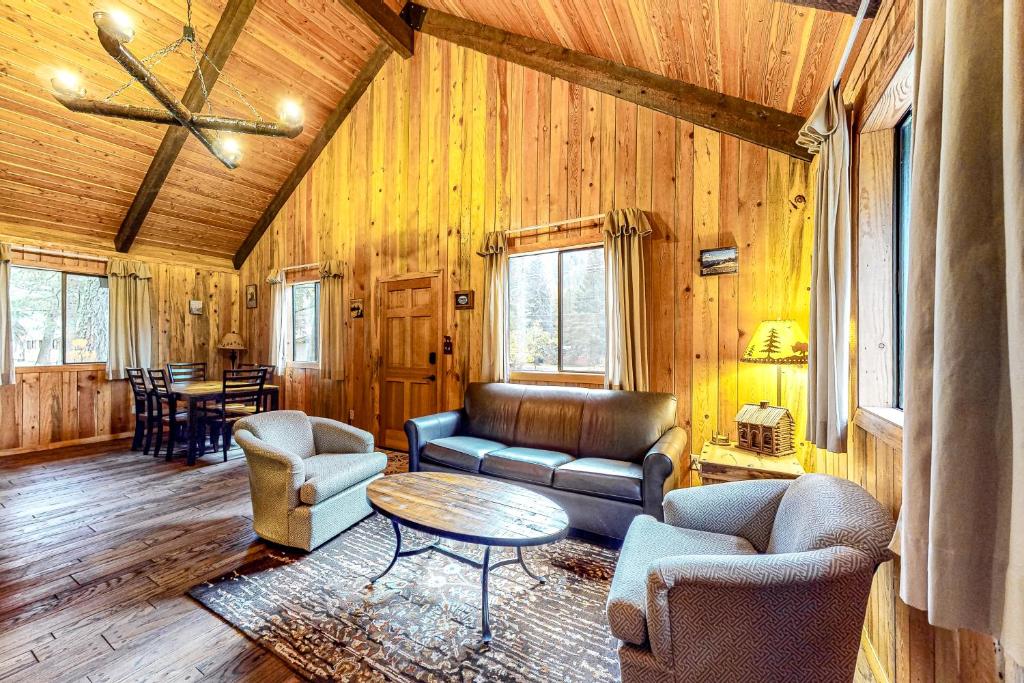 a living room with a couch and chairs and a table at Blue Pine Lodge in Joseph