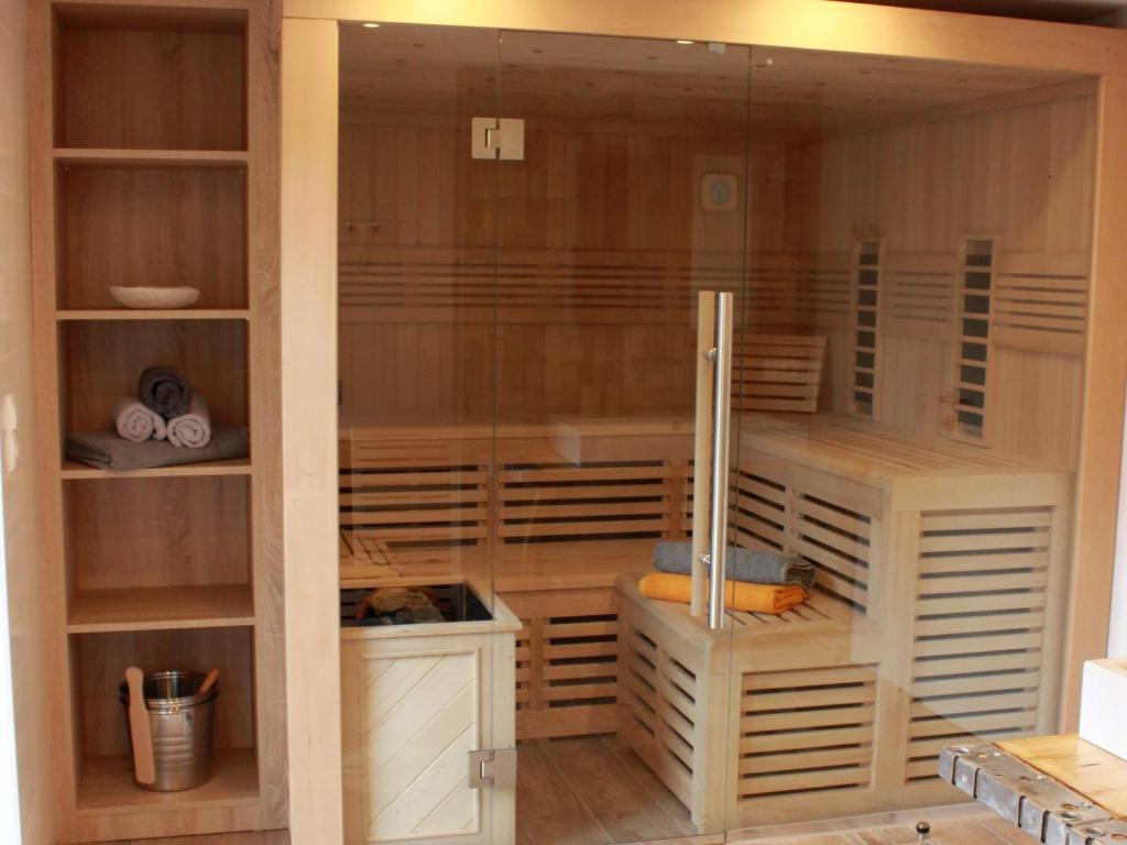 a large closet with a glass door and shelves at Ferienhaus Gerda in Wangerland