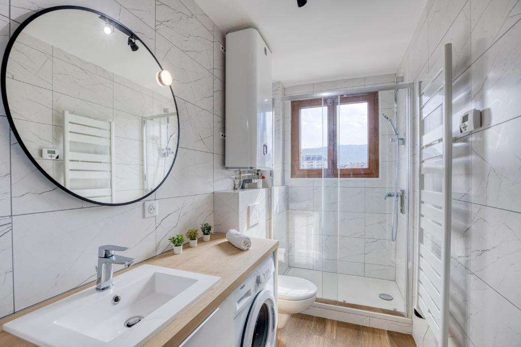 a white bathroom with a sink and a shower at Le Bouvard - MyCosyApart, Central Gare 100m, Netflix in Annecy