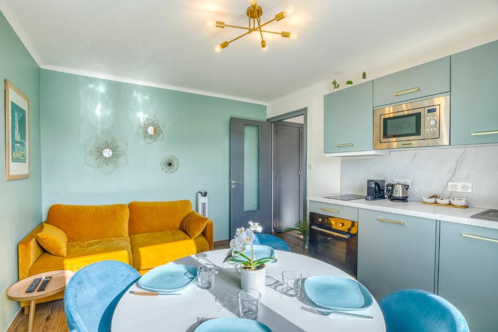 a kitchen and a living room with a table and chairs at Le Bouvard - MyCosyApart, Central Gare 100m, Netflix in Annecy