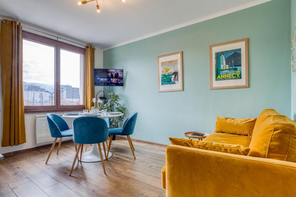 a living room with a couch and a table at Le Bouvard - MyCosyApart, Central Gare 100m, Netflix in Annecy