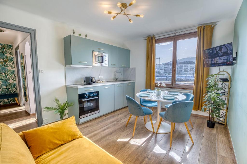 a kitchen and living room with a table and chairs at Le Bouvard - MyCosyApart, Central Gare 100m, Netflix in Annecy