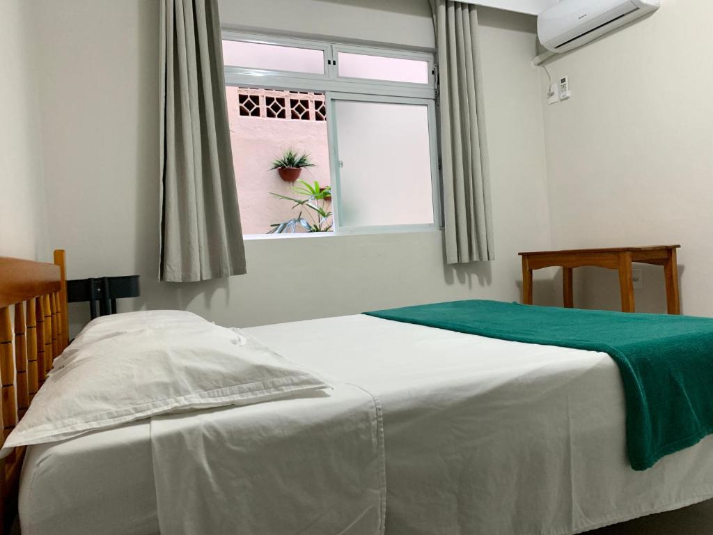 En eller flere senge i et værelse på LOFT Av Brasil bem localizado e Economico com Wi-Fi