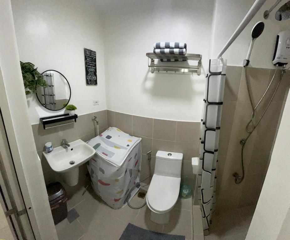 a small bathroom with a toilet and a sink at Lovely 1BR Condo @ SM Southmall w/ Netflix & High Speed WIFI in Manila