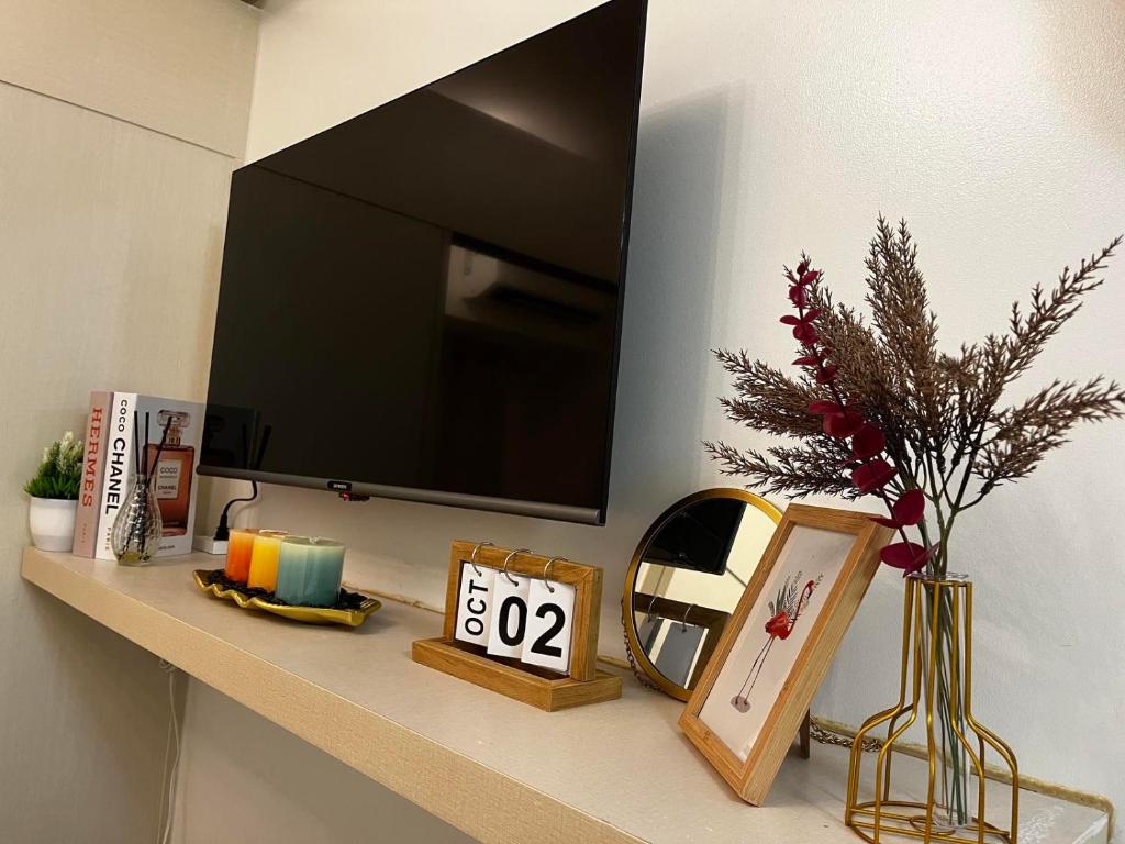 a shelf with a flat screen tv on a wall at Posh 1BR @ SM Southmall w/ 100mbps and Netflix in Manila