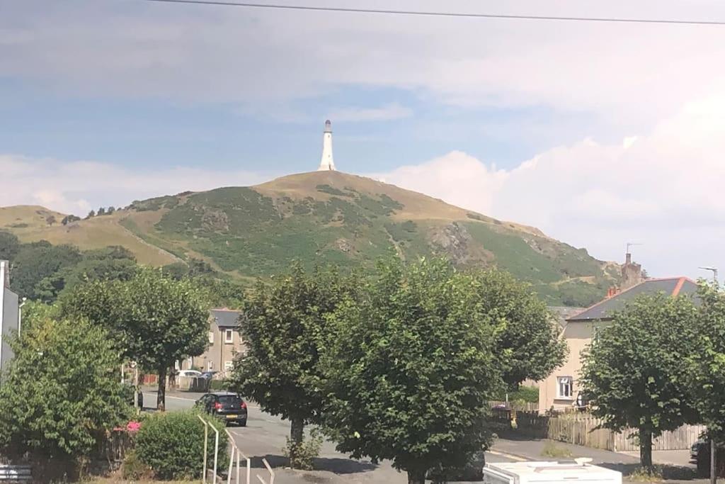a cross on top of a hill with a house at Ulverston first floor apartment with roof terrace in Ulverston