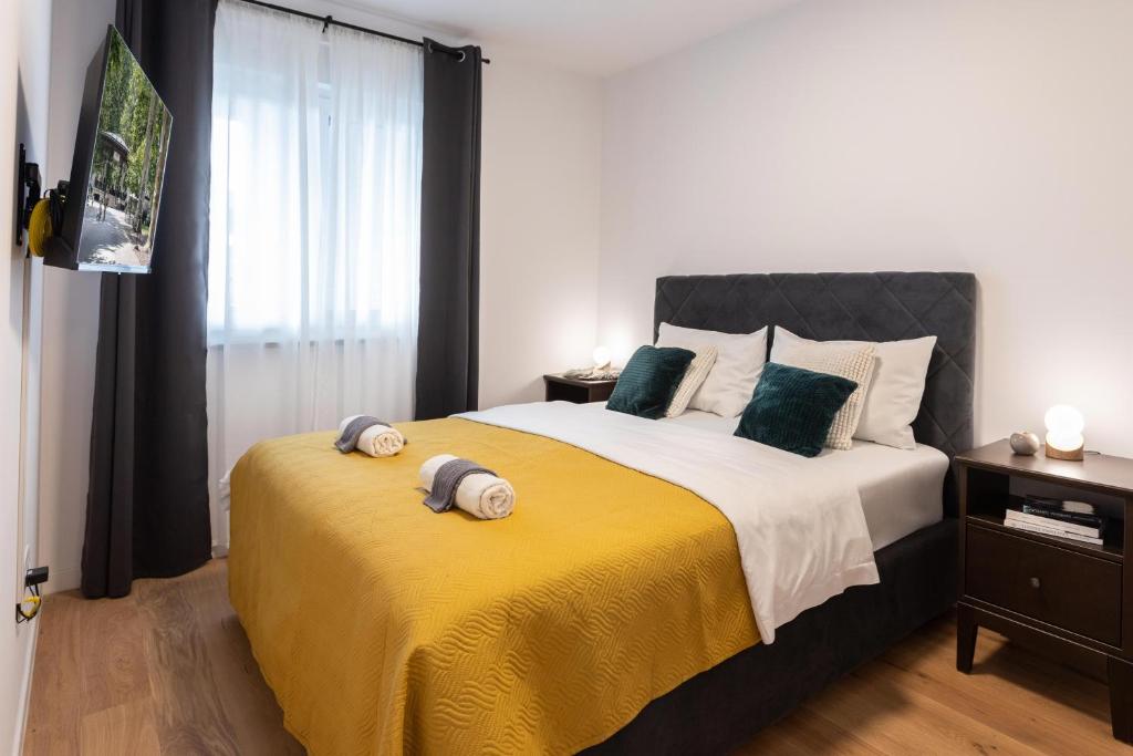 a bedroom with a large bed with two pillows on it at Design 2BDR Apartment with Balcony- FREE PARKING in Zagreb