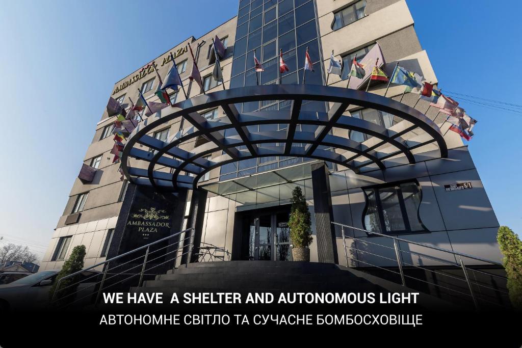 a building with a sign that says we have a shelter and autolis light at Ambassador Plaza in Kyiv