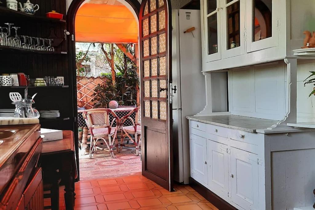 a kitchen with an open door leading to a patio at Villa d'artiste comprenant 2 chambres avec salles de bain privatives in Arcachon