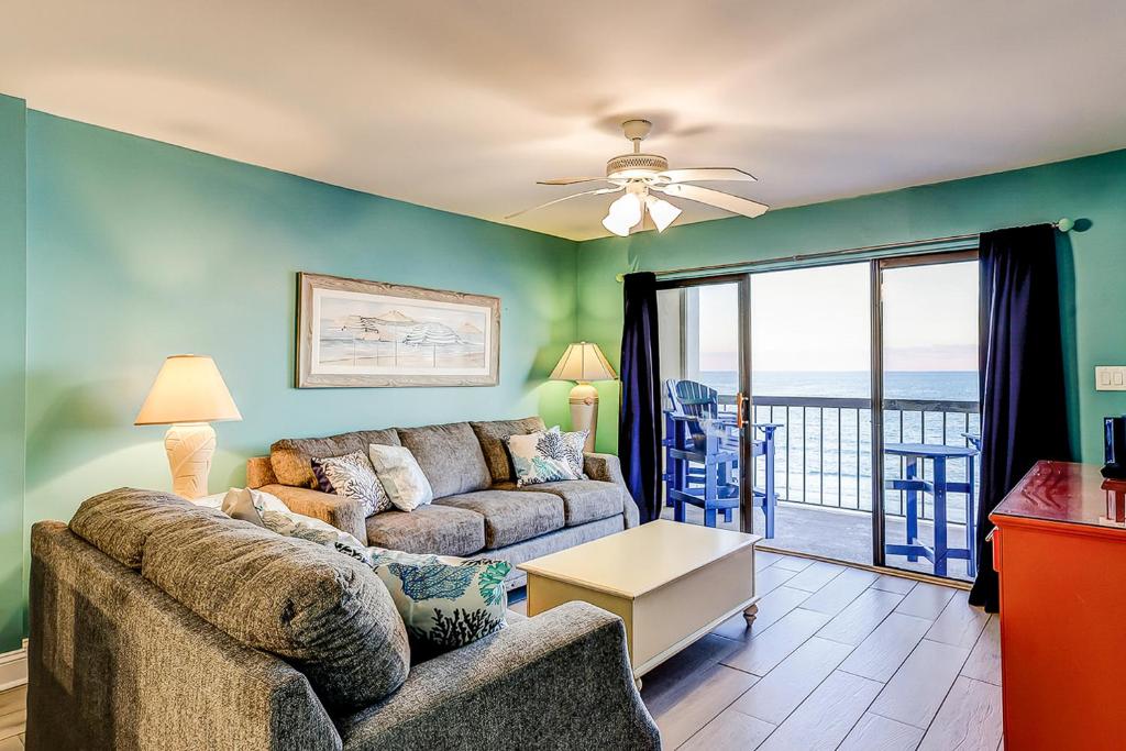 a living room with a couch and a view of the ocean at x Sea Marsh II 503 in Myrtle Beach