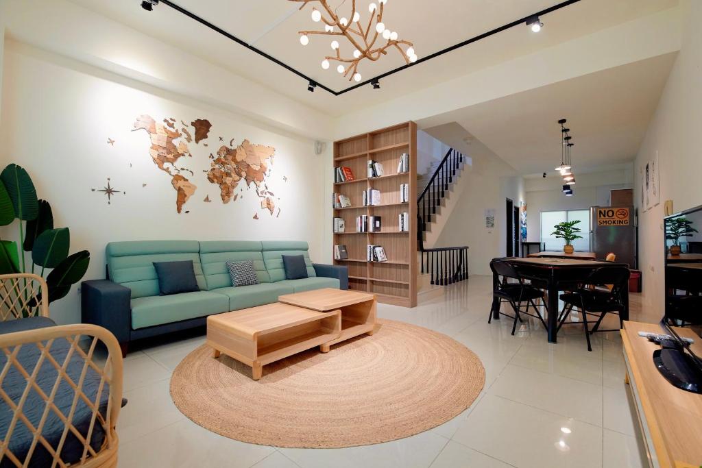 a living room with a blue couch and a table at 台南水沐安平包棟民宿 in Tainan