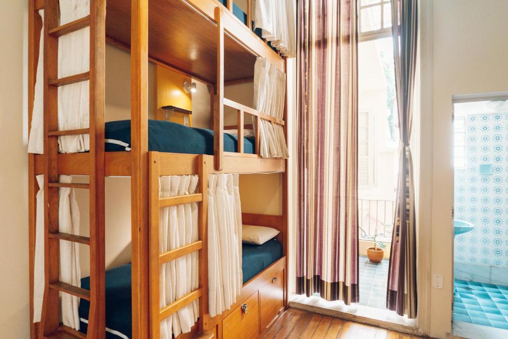 a room with bunk beds with a window at Discovery Hostel in Rio de Janeiro