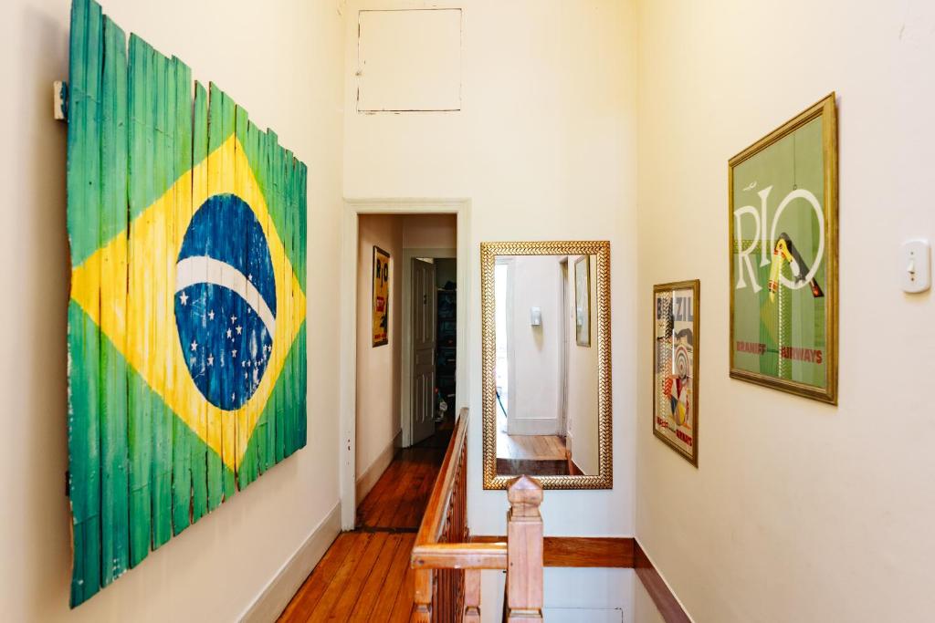 a hallway with paintings on the walls at Discovery Hostel in Rio de Janeiro