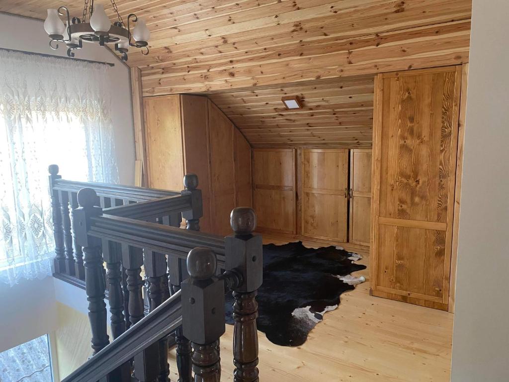 a room with a staircase in a house at Acasa la Tulucu in Bîrsana