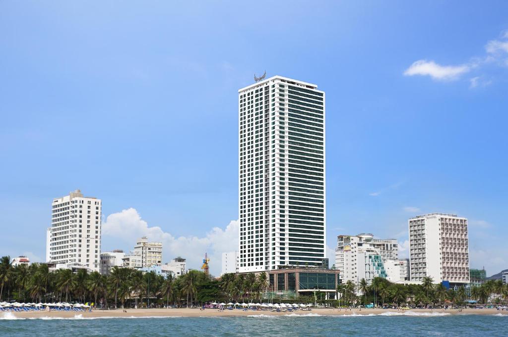 a city skyline with tall buildings and a beach at Muong Thanh Luxury Nha Trang Hotel in Nha Trang