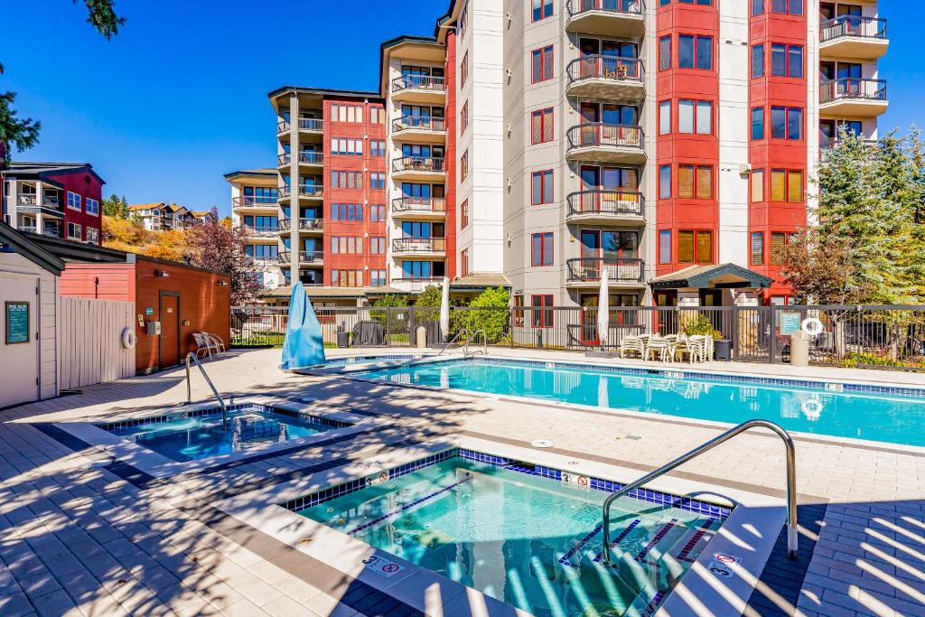 a swimming pool in front of a apartment building at Torian Plum Creekside II in Steamboat Springs