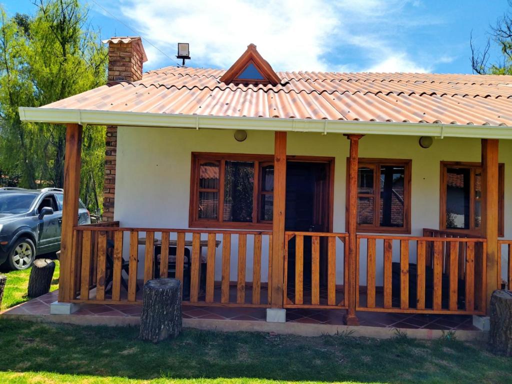 a small house with a porch and a roof at Sol y Luna Villa Campestre in Iza