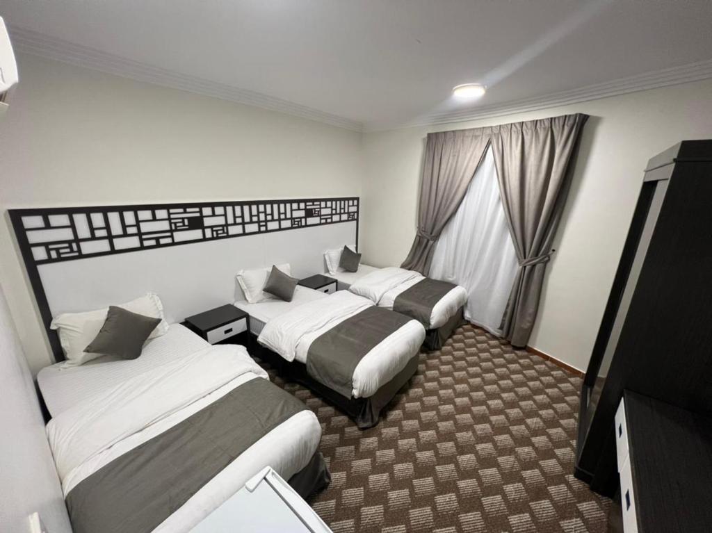 麥地那的住宿－شقق منازل طيبة，酒店客房设有两张床和电视。