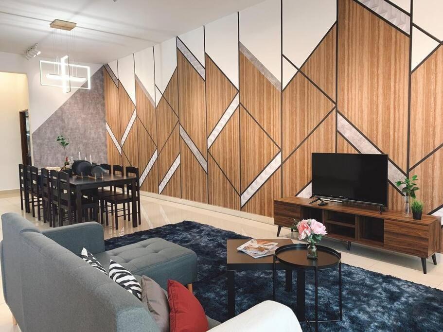 a living room with a couch and a tv at Brand New Cozy Home Desaru Coast Near to SKS waterpark hard rock in Bandar Penawar