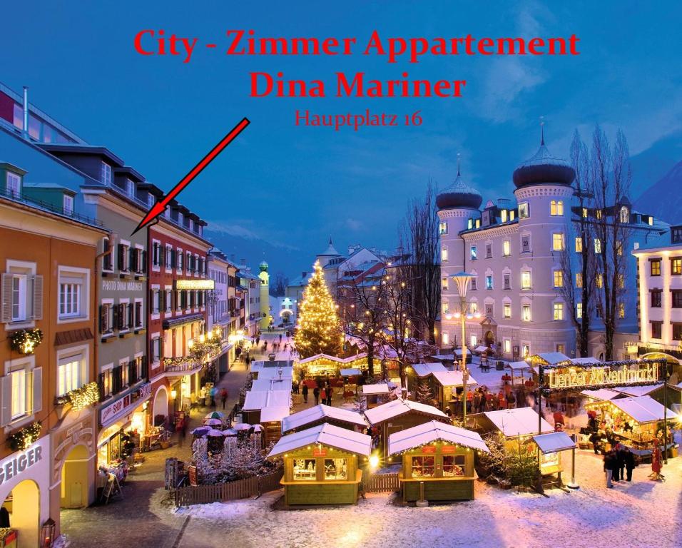 a christmas market in a city with a christmas tree at City Zimmer - Appartement Dina Mariner in Lienz
