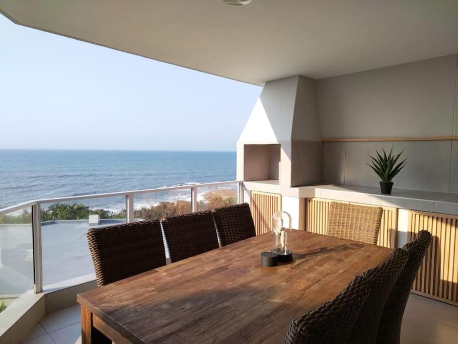 a dining room table with chairs and a view of the ocean at Breathtaking 3 Bedroom unit with amazing sea views in Ramsgate