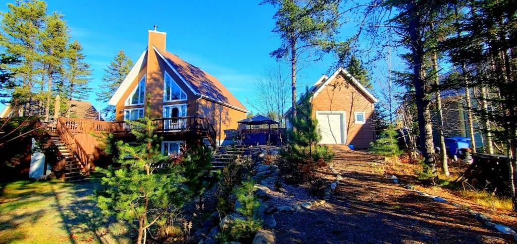 a large wooden house in the middle of a forest at Amazing 3-bedroom entire Chalet-Sauna+lakeview+Spa+BBQ(Best place to relax) in Saint Come