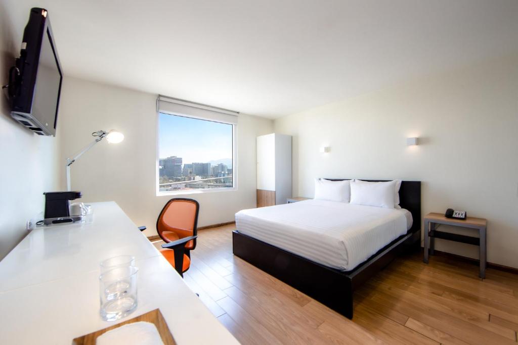 ein Hotelzimmer mit einem Bett und einem Schreibtisch in der Unterkunft Gamma Ciudad de Mexico Santa Fe in Mexiko-Stadt