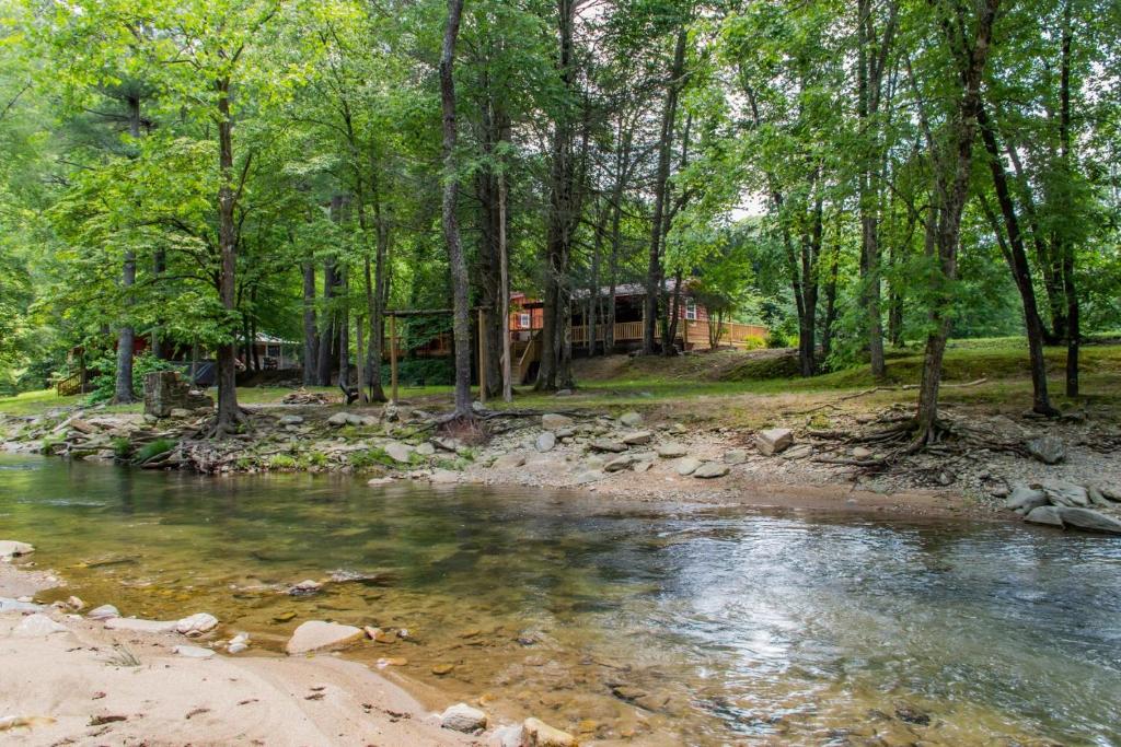 a cabin in the woods next to a river at Twin Creeks Cabin - Anglers Retreat! in Powderhorn Mountain