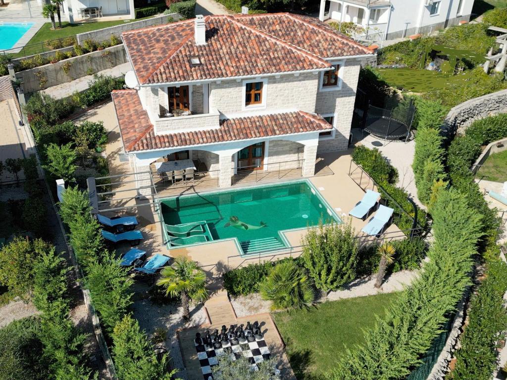 an aerial view of a house with a swimming pool at Villa NOAH in Kornić