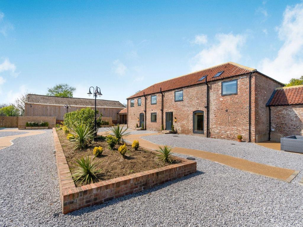 a brick building with a garden in front of it at Partridge Place in Hull